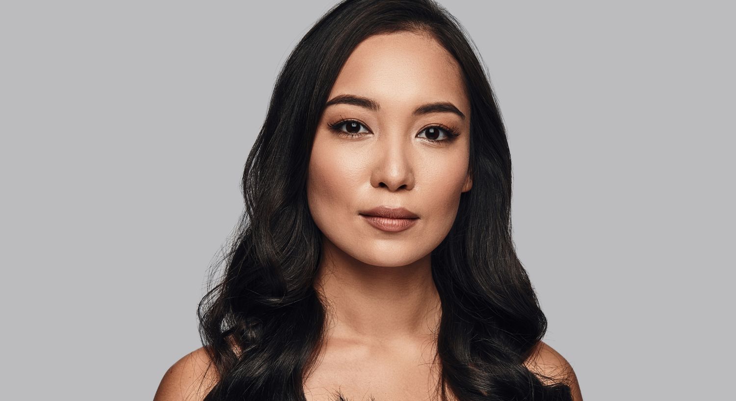 Portrait of a woman with long, wavy hair.